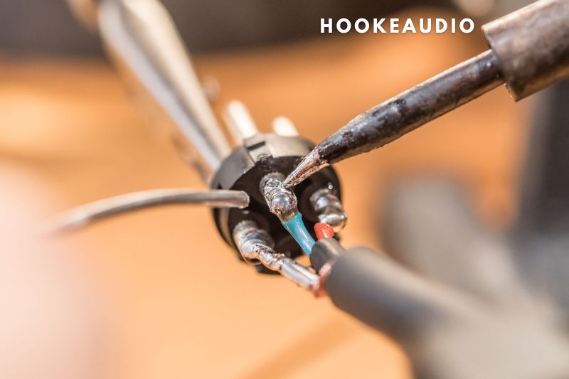 5. Use a soldering iron to detach the wires from the damaged speaker.